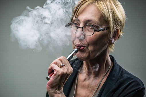 Woman smoking an electronic cigarette.
