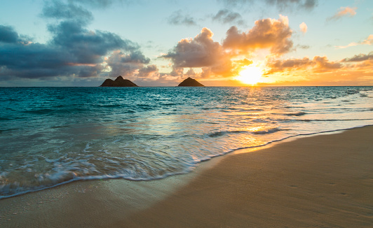 Simple beautiful sunrise over Na Mokulua islands from Lanikai Beach on Oahu, Hawaii