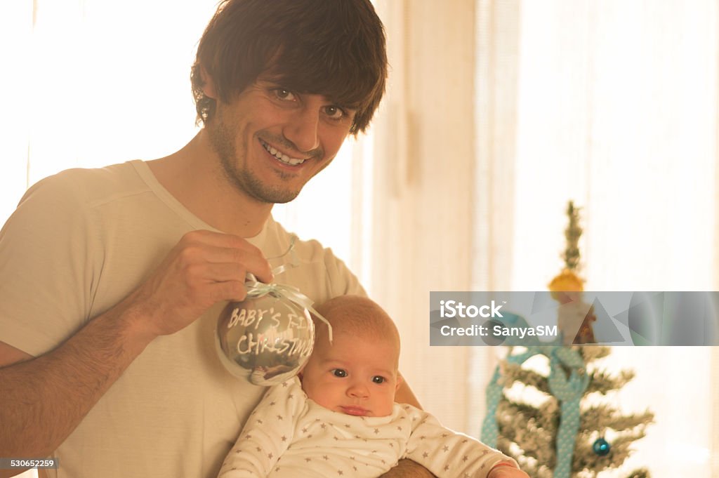 Father and son - Baby's first Christmas Father and son are enjoying baby's first Christmas. Adult Stock Photo
