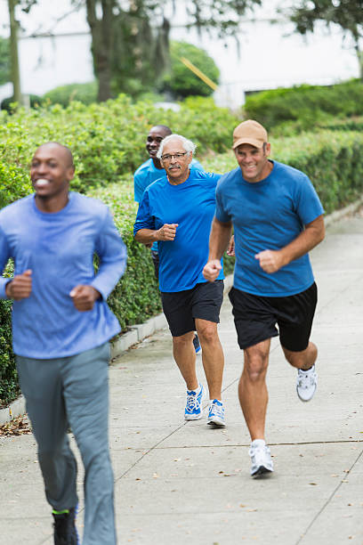 istock Multiracial group of men running in the park 530653111