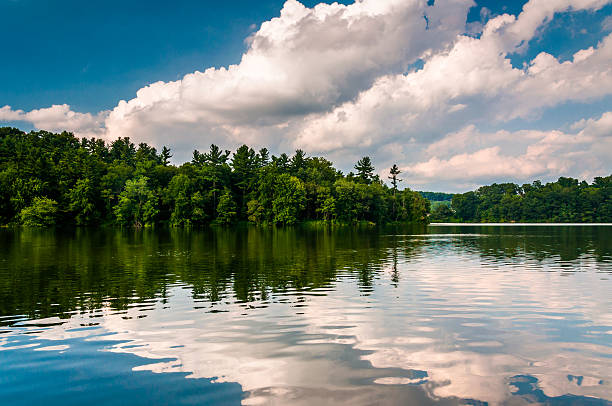 istock Clouds and trees reflecting in Lake Williams, in York, Pennsylva 530653241