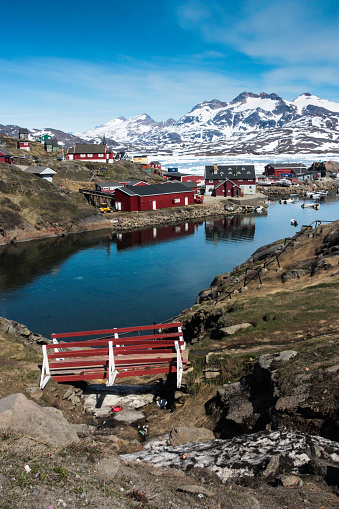 The village of Tasiilaq, Greenland, on the hills above the calm harbour.