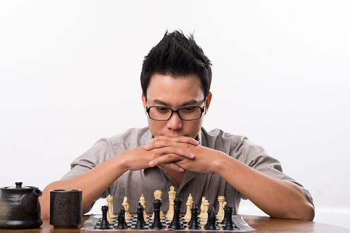 Man playing chess during tournament at table indoors