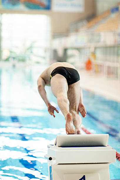 istock Man Preparing Jumping Into Swimming Pool 530659523