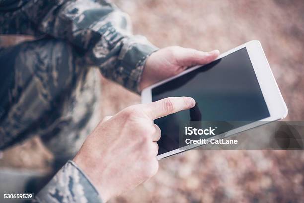 Us Military Soldier Using Digital Tablet In The Field Stock Photo - Download Image Now