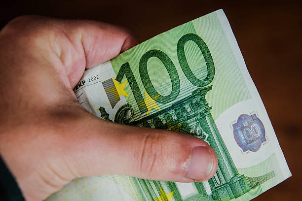 istock 100 euro in hand 530659587