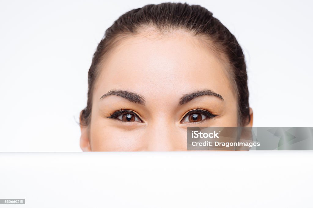 Pretty woman with banner Face of pretty woman behind white banner Behind Stock Photo