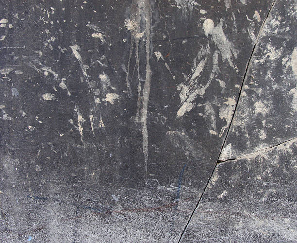 istock dirty worn gray stone wall  with large crack damage 530661279