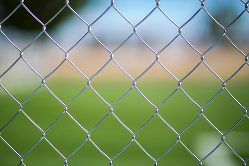 Germany, Berlin, January 27, 2024 - Full frame of chain-link fence against field, Berlin Zehlendorf