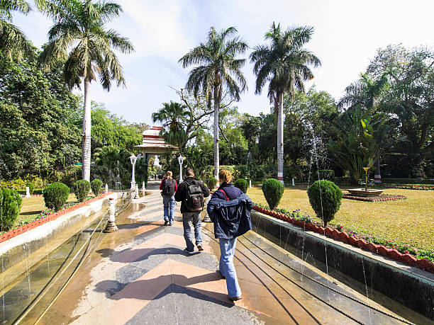 Tourists walking in alley of Saheliyon Ki Bari park in Udaipur, town in Rajasthan, India, known as Venice of East as it has many Palaces and Lakes. It is a tourist destination.