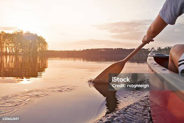 Woman Canoeing At Sunset Stock Photo - Download Image Now - Canoeing, Oar, Lake