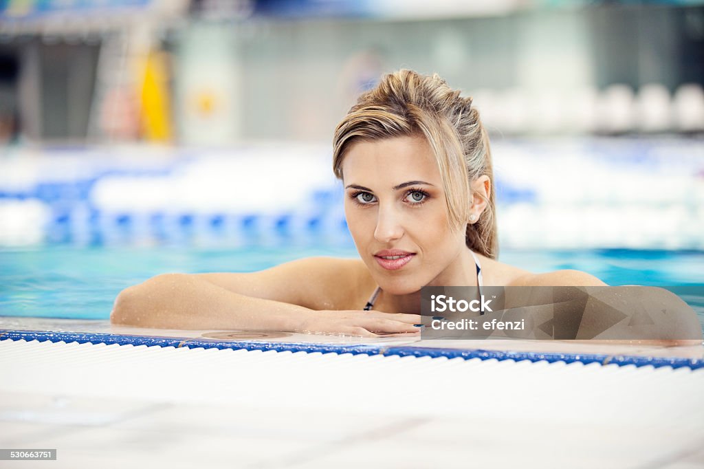 Blond Woman In Water Portrait of an attractive blond woman in bikini posing in a swimming pool. 20-24 Years Stock Photo