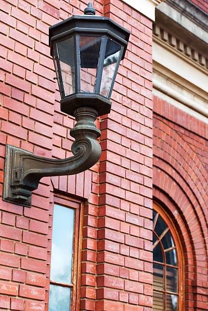istock Vintage lantern on brick wall with window 530667345