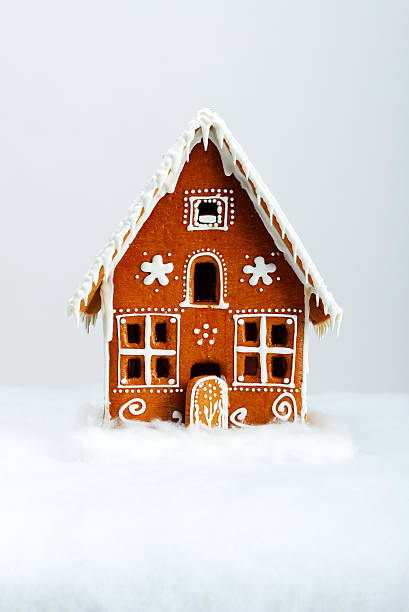 The hand-made eatable gingerbread house and snow decoration stock photo