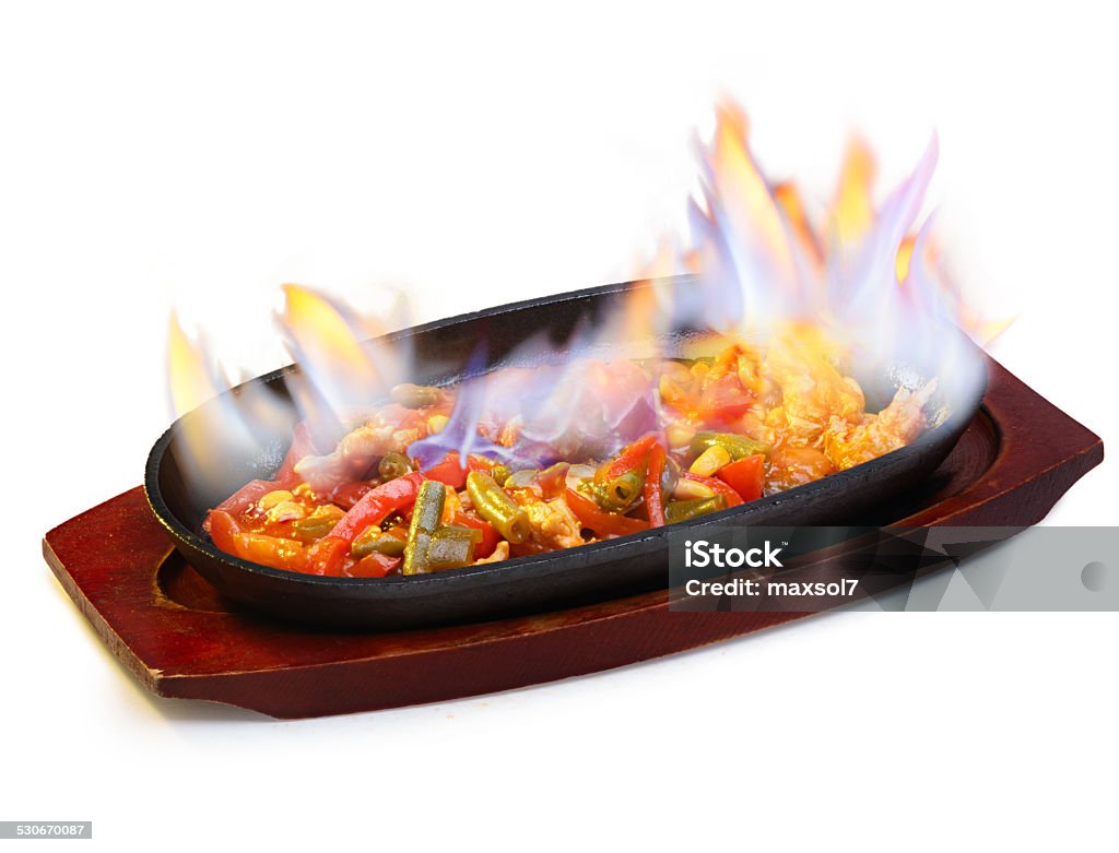 Burning fajitas Sizzling and burning fajitas on a frying pan Beef Stock Photo