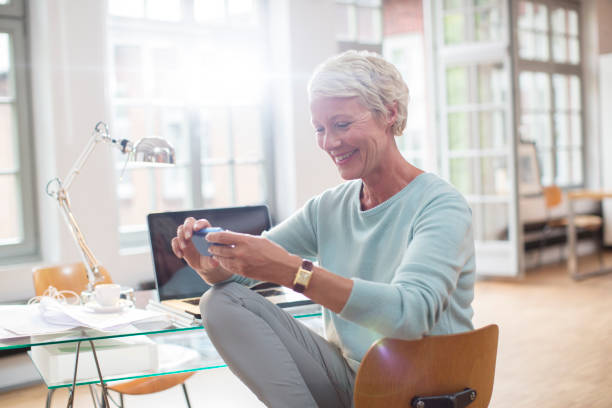 istock Businesswoman using cell phone at home office desk 530681469