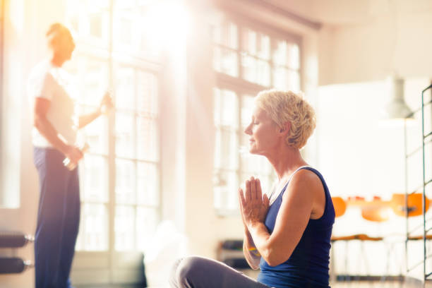 istock Older woman meditating on floor 530681539