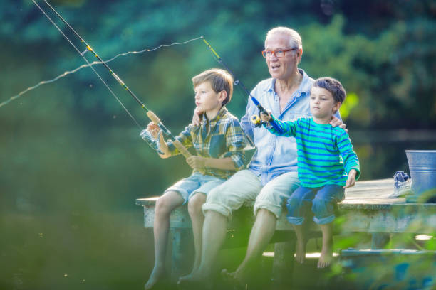 avô e netos pescando em lago - fishing lake grandfather grandson - fotografias e filmes do acervo