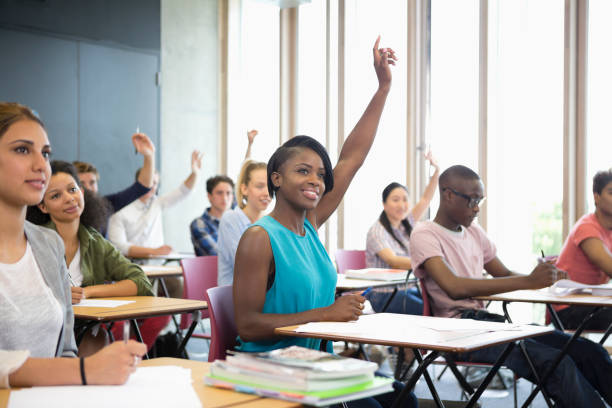 istock Motivated university students raising their hands at seminar 530682643