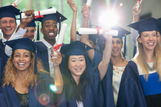 istock Smiling university students standing in corridor with their diplomas after graduation ceremony 530682937