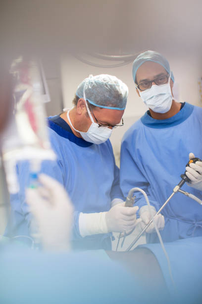 istock Mature doctors performing surgery and controlling liquid in saline bag 530684781