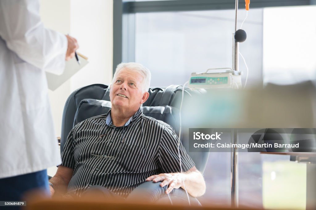 Doctor talking to patient receiving medical treatment in hospital ward  Chemotherapy Drug Stock Photo