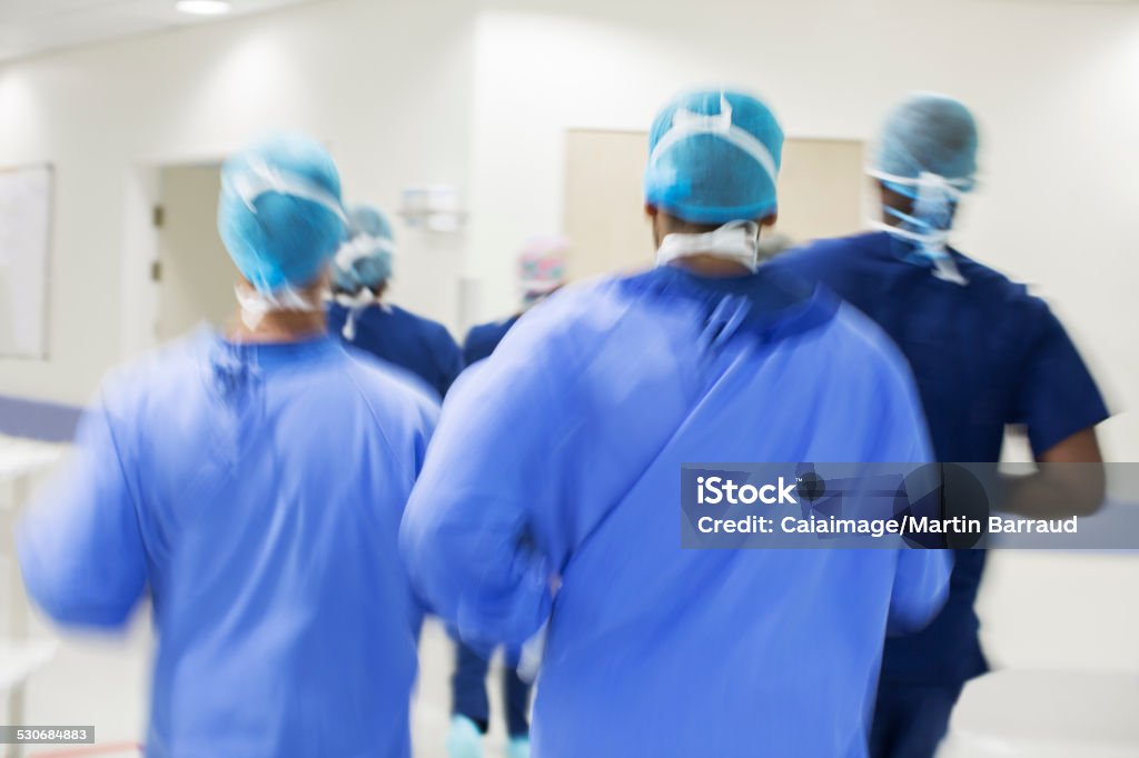 Blurred motion of surgeons walking towards hospital  25-29 Years Stock Photo