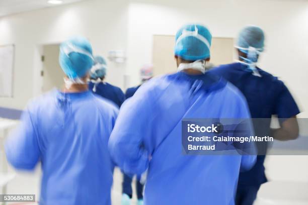 Blurred Motion Of Surgeons Walking Towards Hospital Stock Photo - Download Image Now