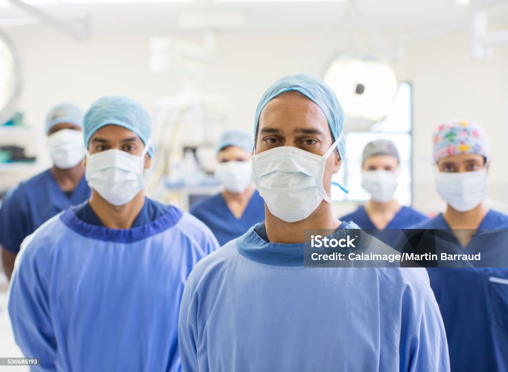 Group portrait of team of masked surgeons in hospital  Surgeon Stock Photo
