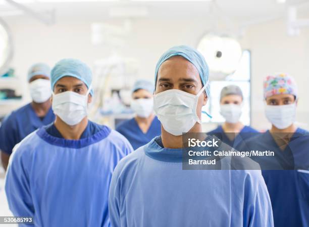 Group Portrait Of Team Of Masked Surgeons In Hospital Stock Photo - Download Image Now