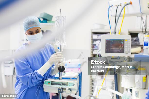 Nurse Standing By Medical And Monitoring Equipment Stock Photo - Download Image Now - Female Nurse, Intensive Care Unit, Medical Equipment