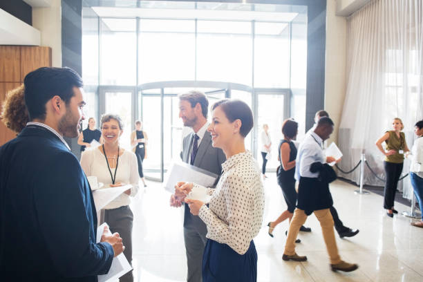 Group of business people standing and talking in office  event stock pictures, royalty-free photos & images