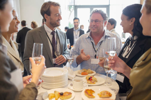 istock Business people standing by table in office, talking and drinking champagne 530685823