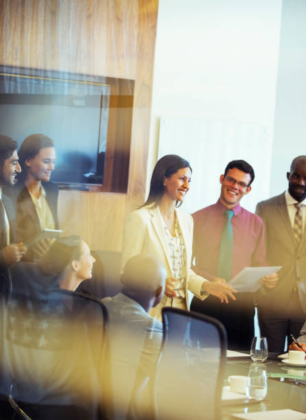 group of business people smiling and discussing in conference room - business conference meeting teamwork imagens e fotografias de stock