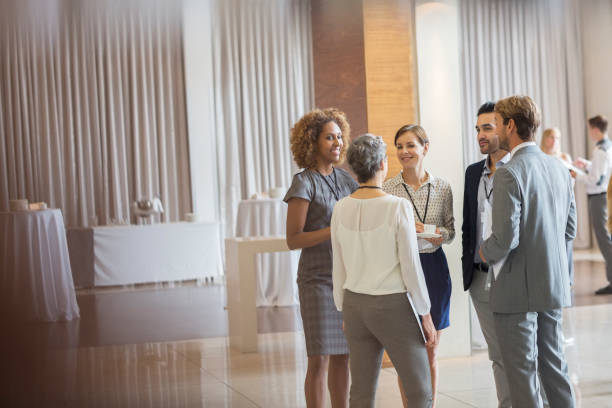 istock Business people standing in conference room, talking and smiling 530685991