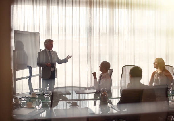 istock Business people attending presentation in conference room, gesturing and discussing 530686009