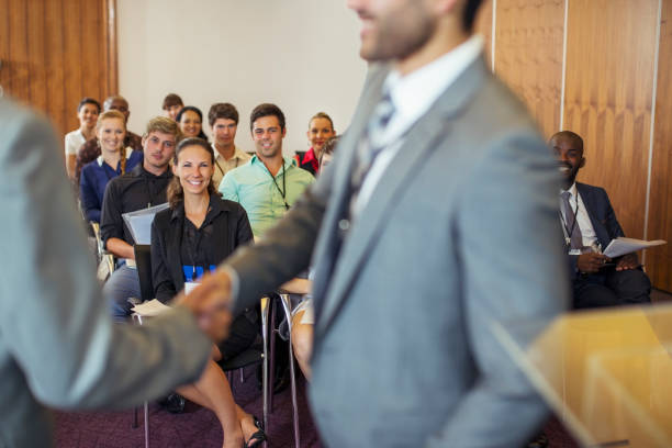 istock Two businessmen shaking hands during conference in conference room 530686041