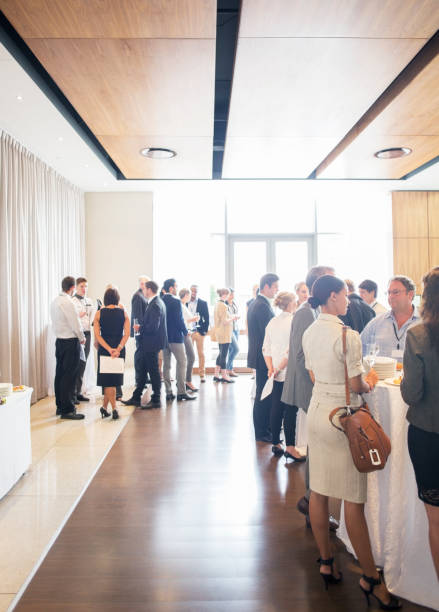 large group of people socializing in lobby of conference center during coffee break - business vertical talking usa imagens e fotografias de stock