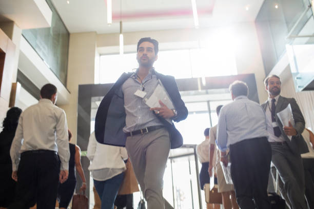 istock Men holding documents and running in office corridor 530686163