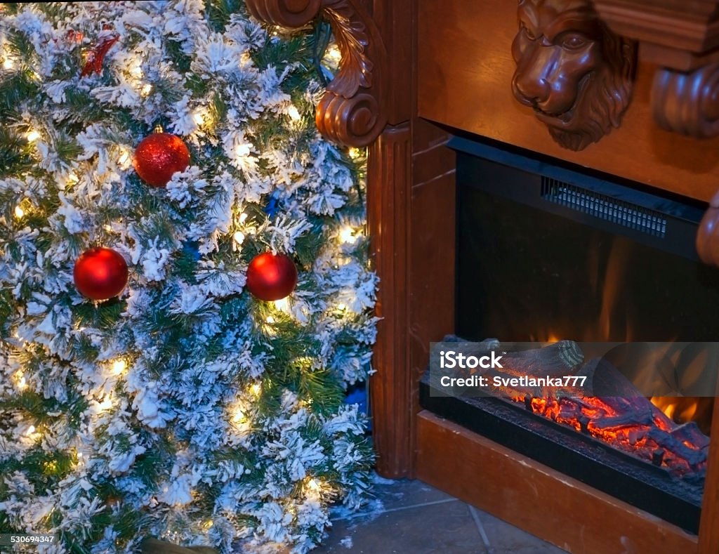 Christmas tree and fireplace. Decorated Christmas tree near fireplace. Christmas Stock Photo
