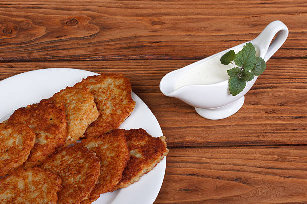 istock Potato pancakes with sour cream sauce and mint 530697229