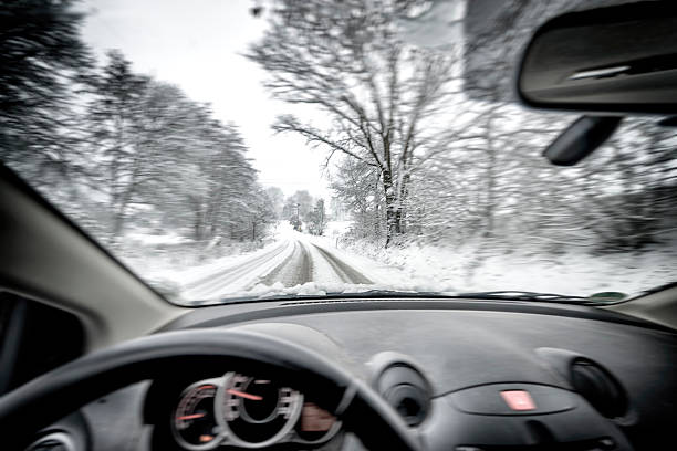istock Snowfall,Country Road driving 530697477
