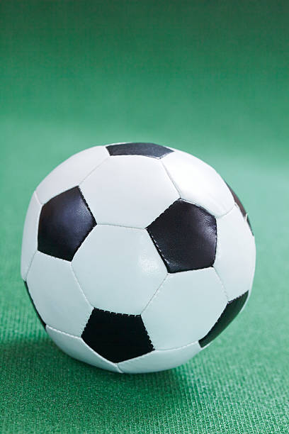 istock soccer ball on a green field 530698081