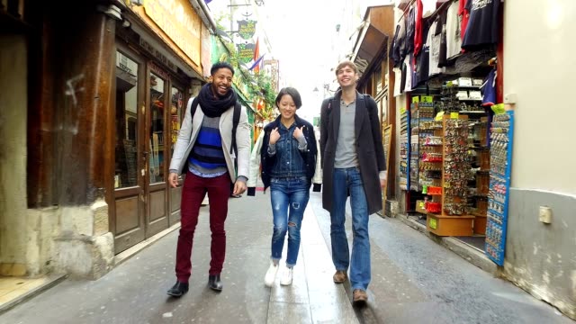 Group of friends visiting Paris, walking through the Latin Quarter (Quartier Latin)