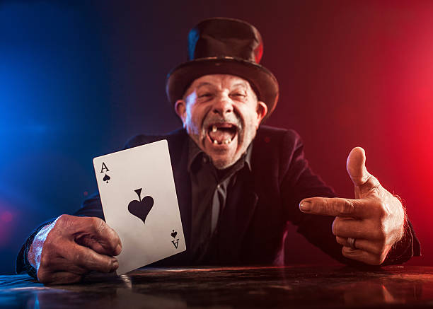 istock Senior man making trick with playing cards 530703879