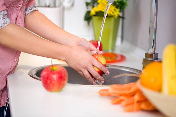 istock washing apple in the sink home kitchen 530705075