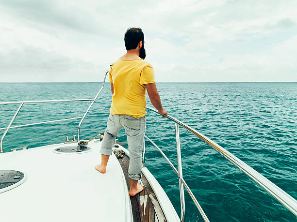 istock Bearded man looks to the horizon while sailing. 530705759