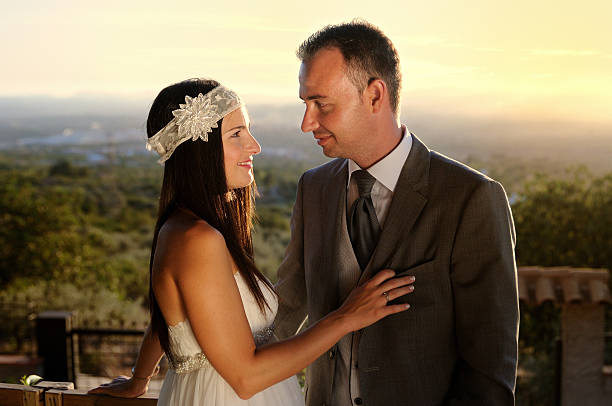istock bride and groom eye contact at sunset 530706435