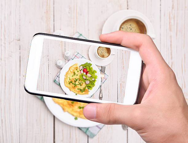 istock Hands taking photo egg omelette with smartphone 530706787
