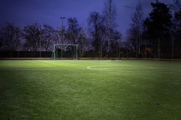 Soccer field Empty soccer field at night. baseline stock pictures, royalty-free photos & images